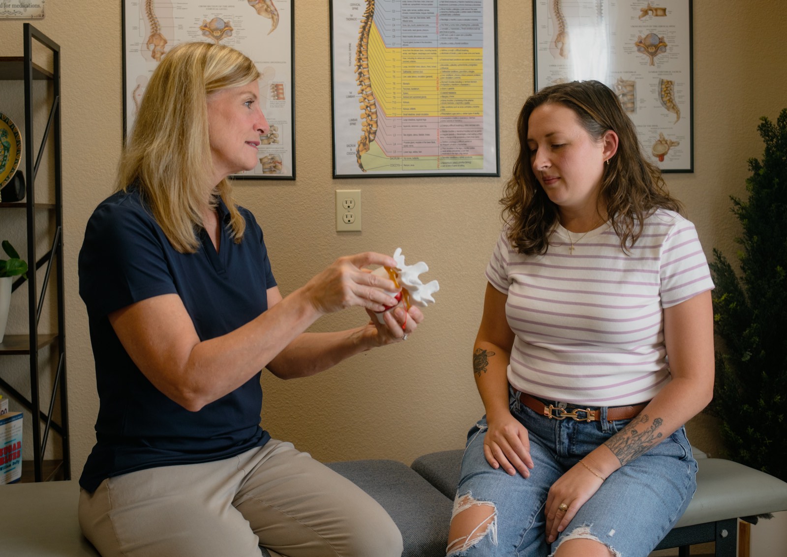 Dr. Emily explaining the spine to a patient during a consultation.