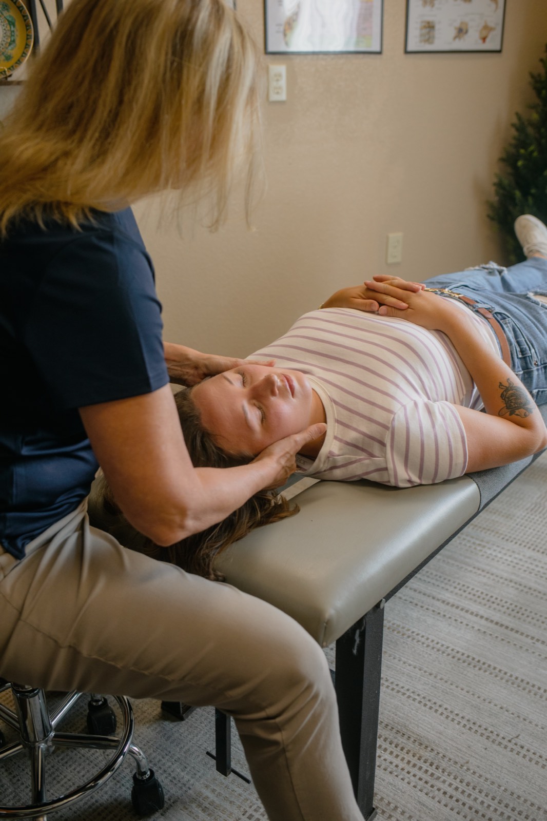 Dr. Emily performing a precise neck adjustment for a patient at Lorena Chiropractic.